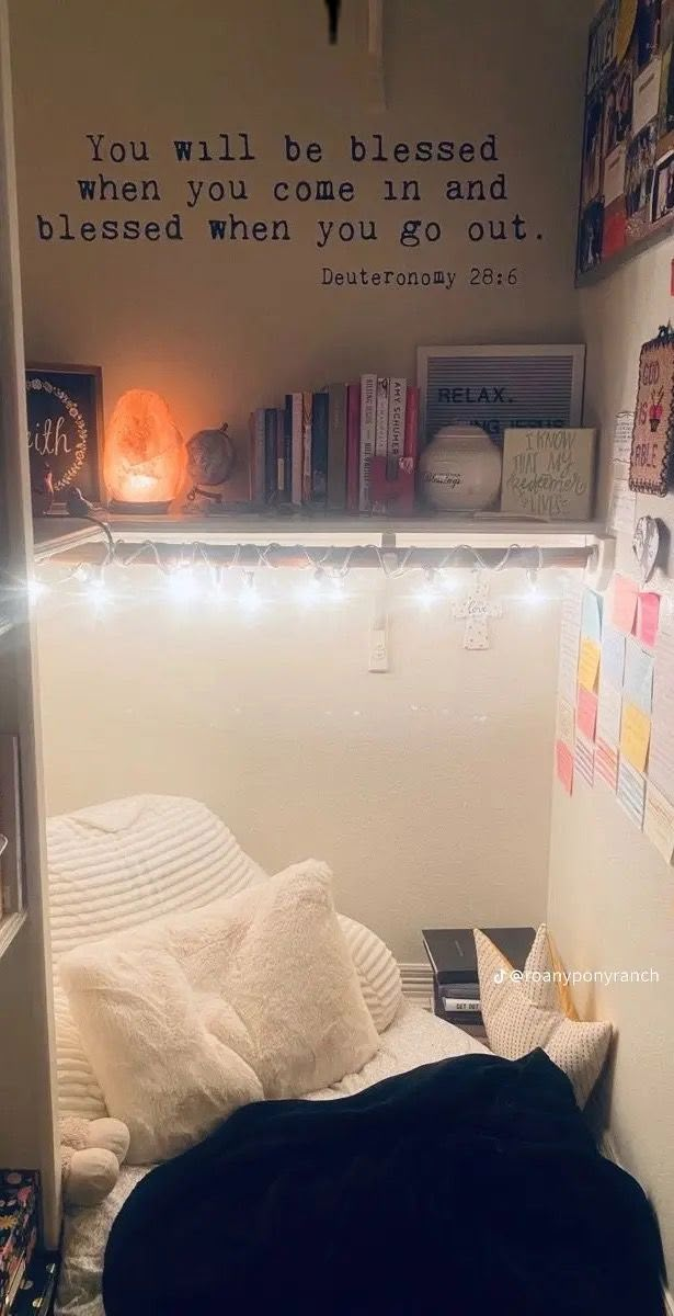 there is a small bed with lights on the headboard and bookshelf behind it