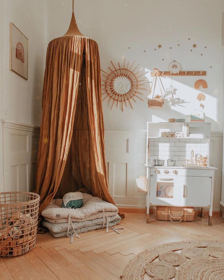 a bedroom with a canopy bed and lots of pillows on the floor in front of it