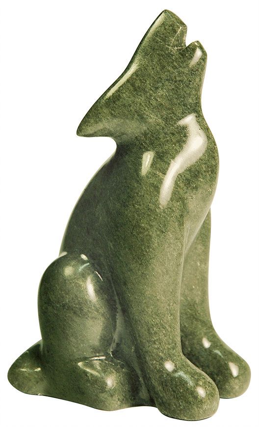 a green cat statue sitting on top of a white surface