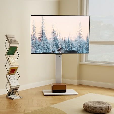 a flat screen tv sitting on top of a wooden stand in front of a window