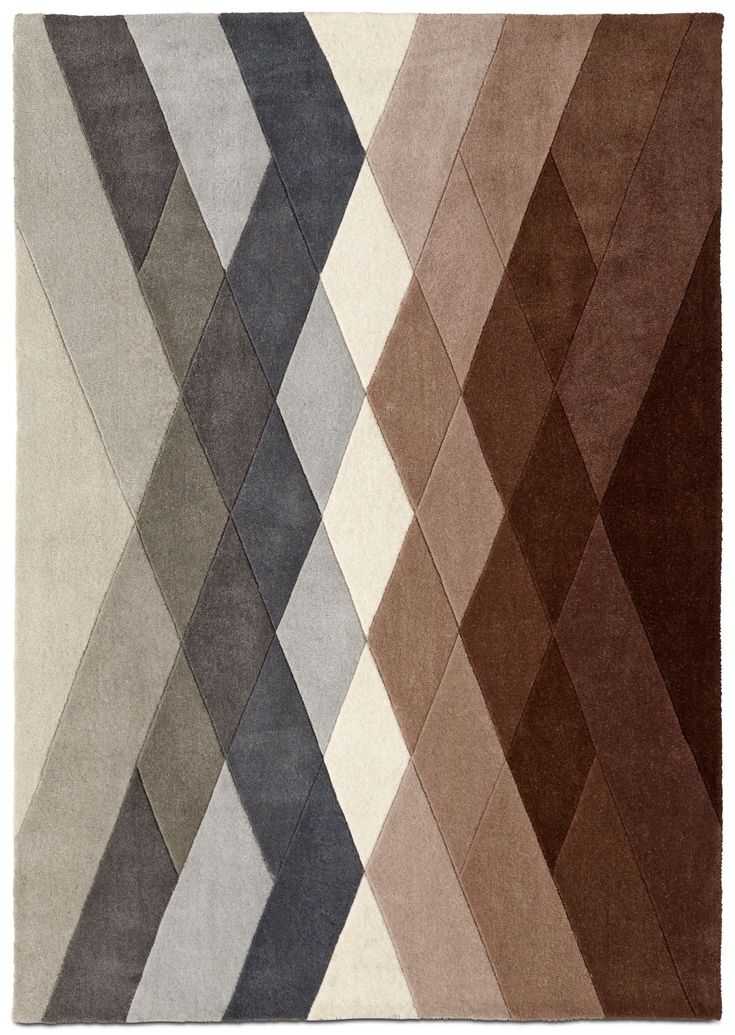 an area rug with different colors and shapes on it, including brown, white, gray, and beige