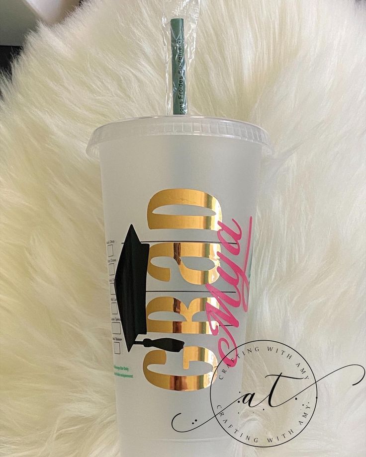 the tumbler cup is decorated with gold foil and has a black arrow on it