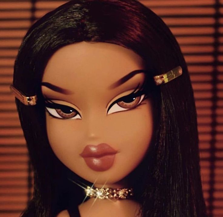 a close up of a doll with long black hair and gold accessories on her head