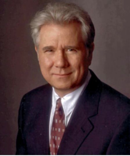 an older man wearing a suit and tie