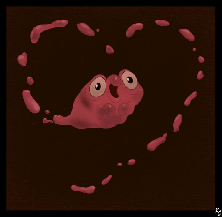 a heart shaped object with two eyes and blood on the ground in front of it