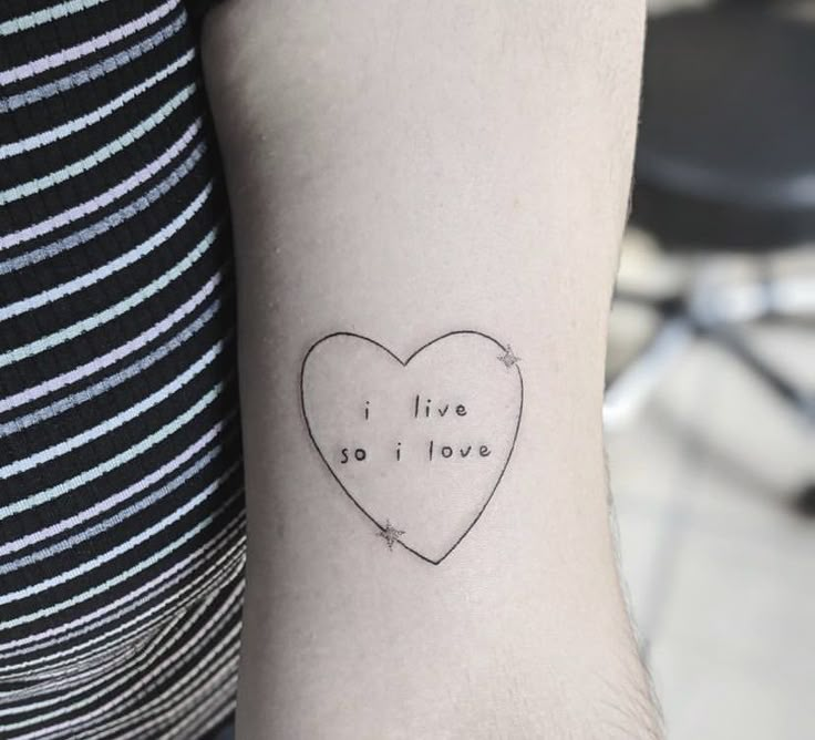 a small heart tattoo with the words i love you written in cursive font