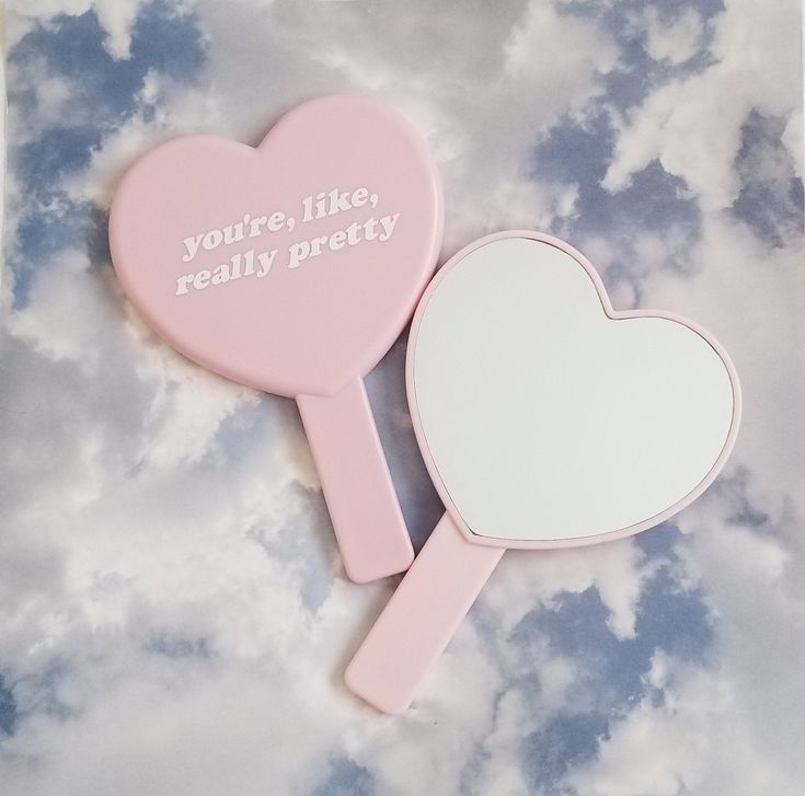 two pink heart shaped mirrors with the words you're like really pretty on them