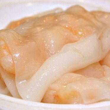 a white bowl filled with dumplings on top of a table