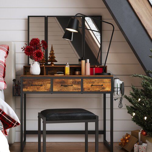 a bedroom with a desk, chair and christmas tree in the corner next to it