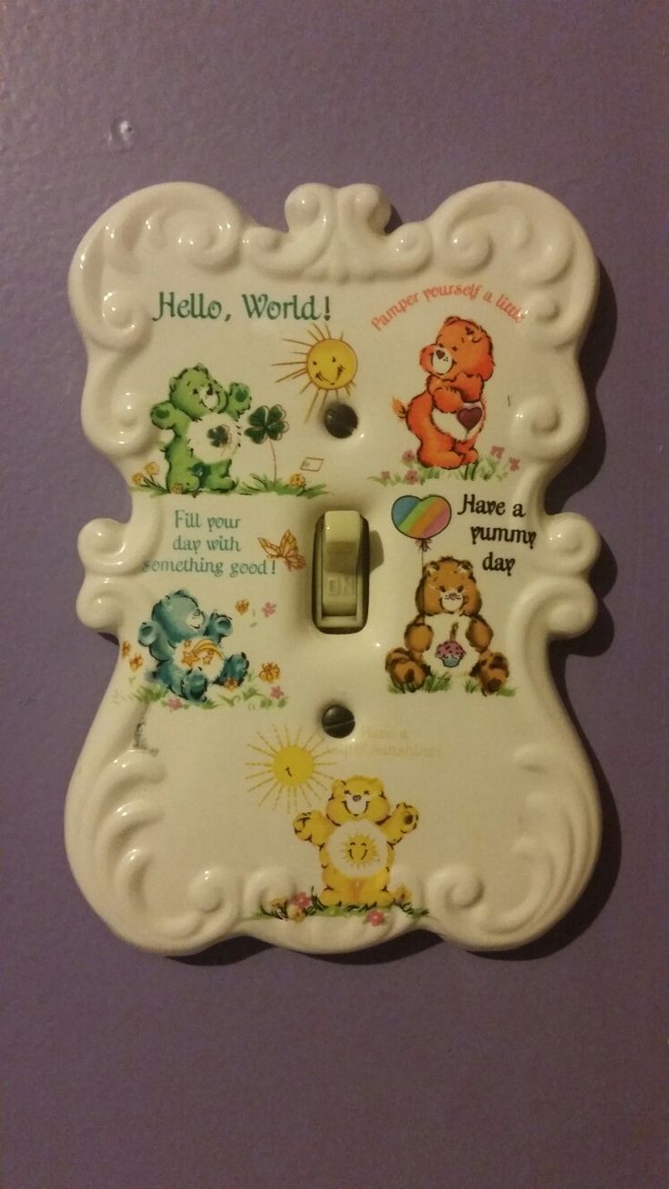 a white light switch with winnie the pooh pictures on it