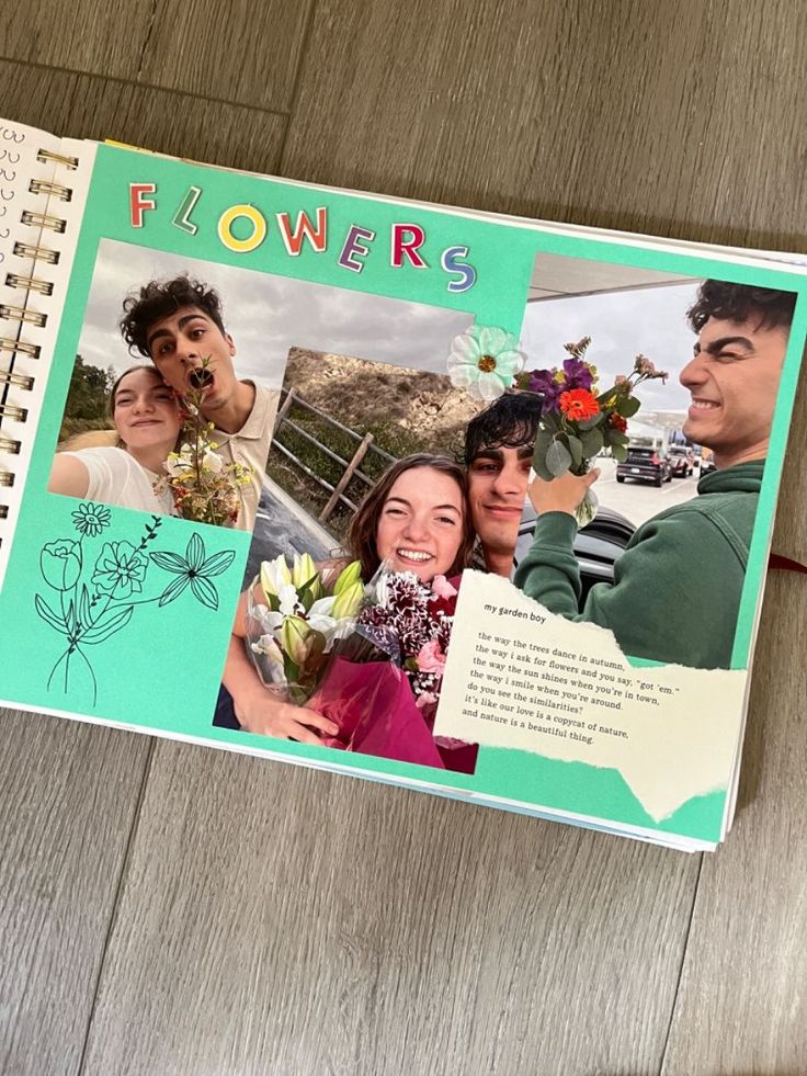 an open book with pictures of people and flowers on the cover, sitting on a wooden floor