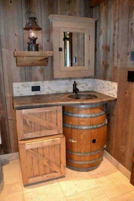 a bathroom with a sink and wooden barrel