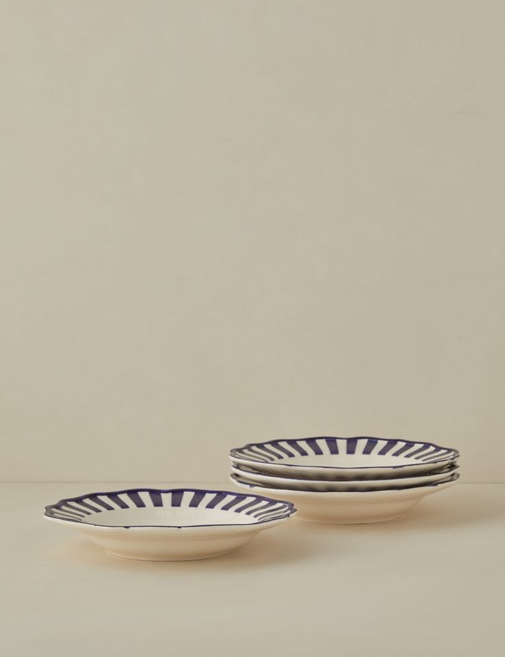 three white and black plates sitting next to each other