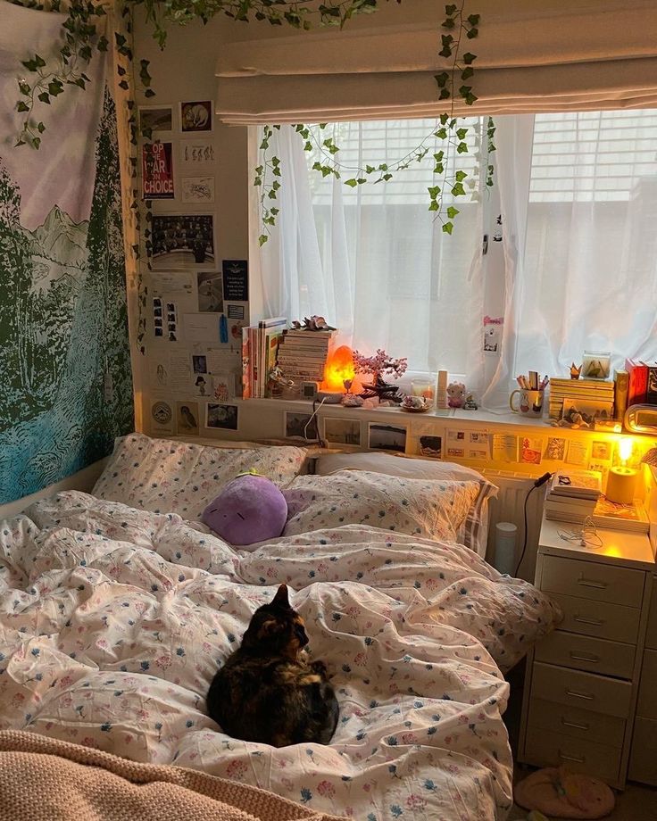 a cat laying on top of a bed in a bedroom