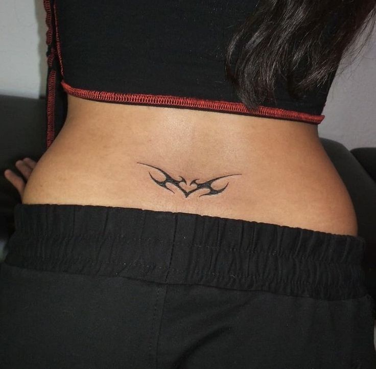 a woman's lower back tattoo with two birds on her stomach and the word love written in cursive font