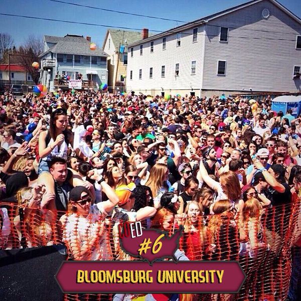 a large group of people standing in front of a building with the words bloomsburg university on it