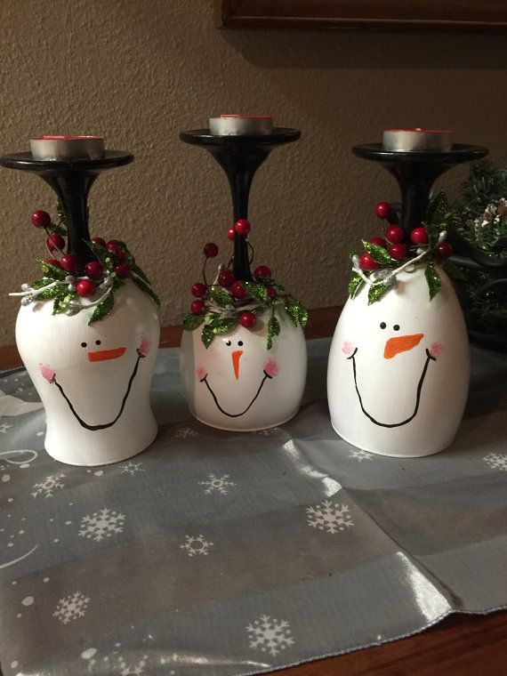 three white vases with snowmen painted on them sitting on top of a table