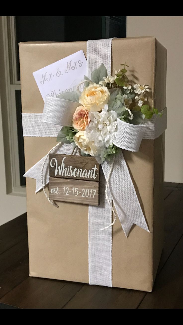 a brown box with flowers and a sign on it