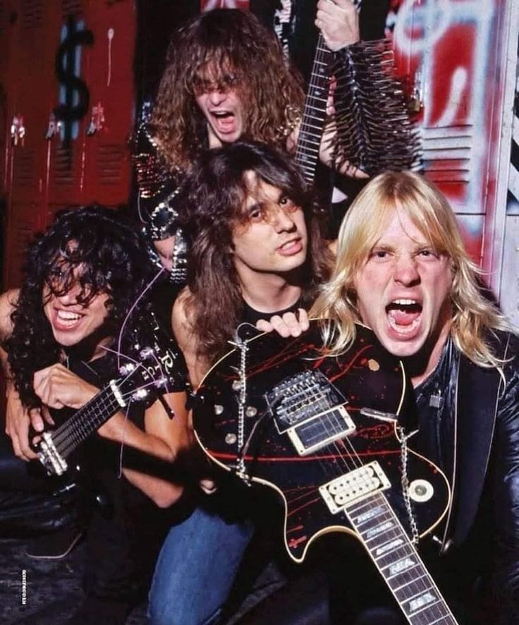 the band slayer posing with their guitars