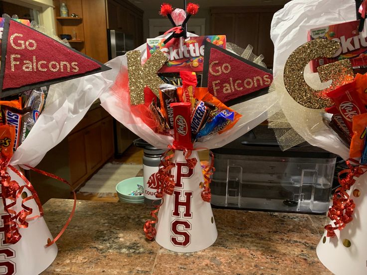 two vases filled with candy sitting on top of a counter