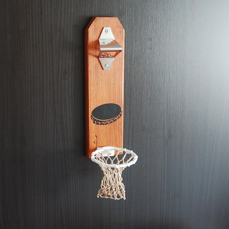 a basketball hoop mounted to the side of a wooden wall hanging on a black door