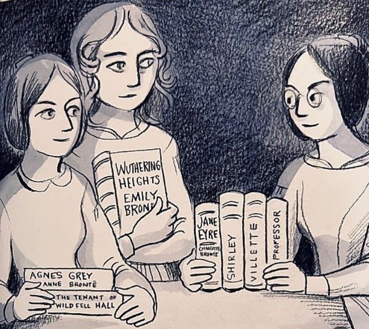 three women sitting at a table holding up books