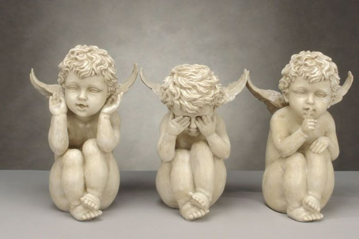 three little cherubs sitting next to each other with their hands on their chests