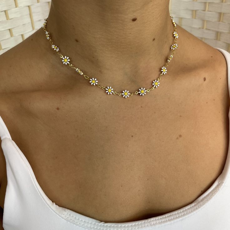 Have you ever seen a cuter necklace? We're feeling all the summer vibes with our new Daisy white choker! Throw this on with a swimsuit or even a fancy outfit and you'll be the best dressed anywhere you go! 13 inches w/ 2.5 inch extenderacrylic flowers, gold plated over brass Daisy Necklace Aesthetic, Summer Festival Necklace With Adjustable Chain, Dainty Necklace For Vacation, Trendy White Necklace For Spring, Casual Summer Jewelry With Adjustable Length, Summer Gift Jewelry With Adjustable Length, White Flower Jewelry For Vacation, Trendy Flower Necklace For Beach, White Adjustable Choker Jewelry