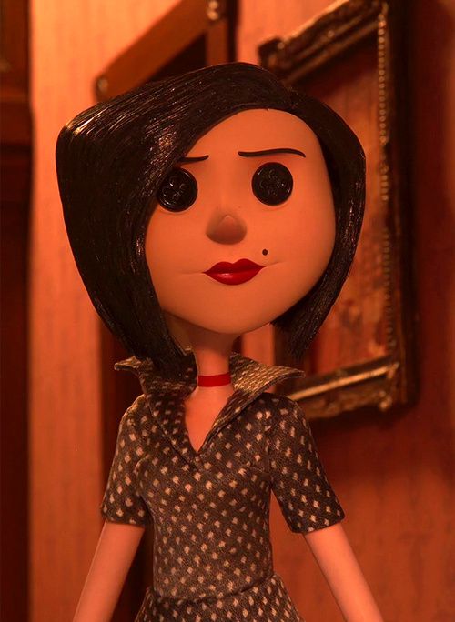 a doll with black hair wearing a polka dot dress