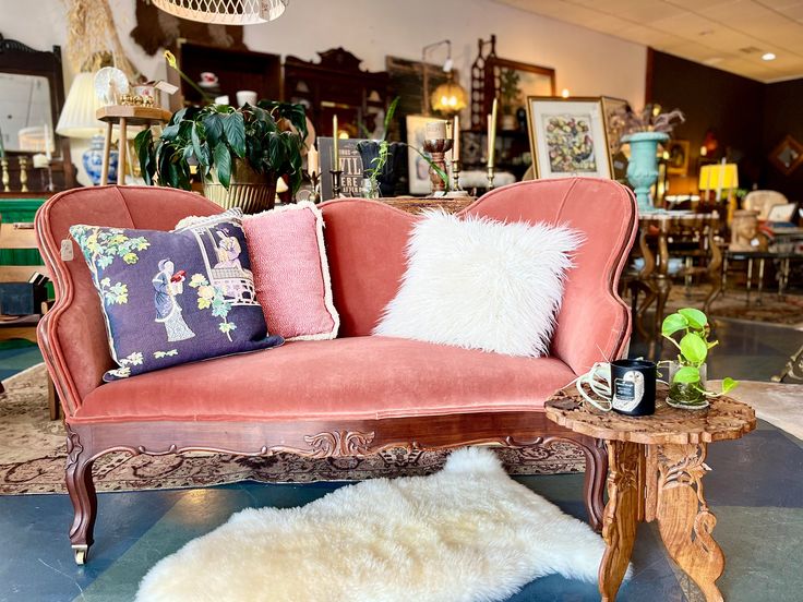 a living room filled with furniture and lots of pillows on top of each other's back