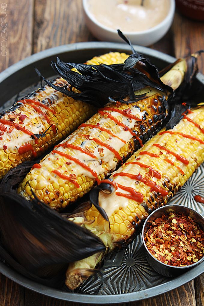 grilled corn on the cob with ketchup and mustard