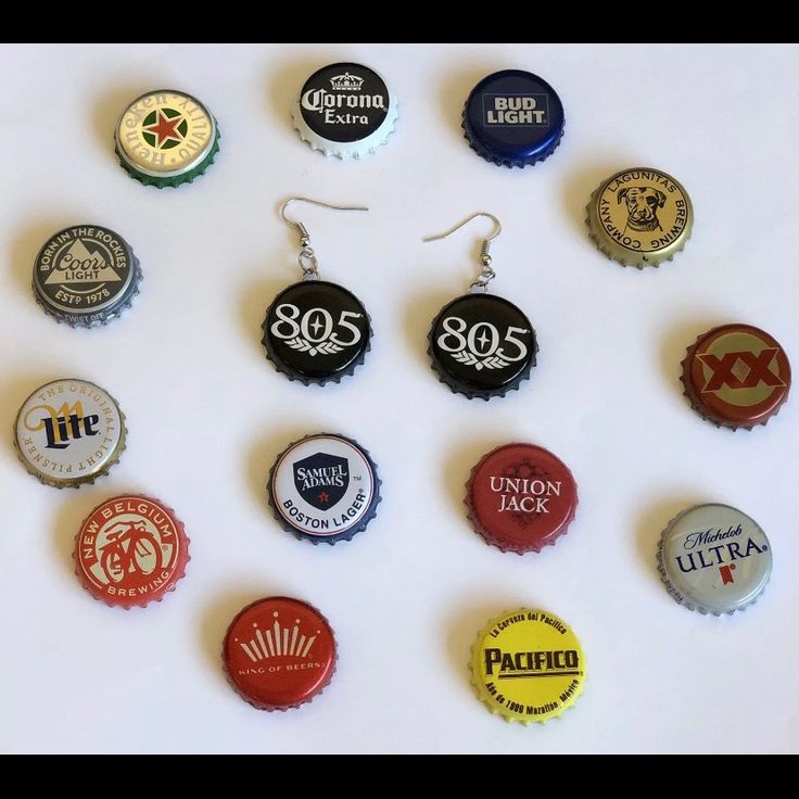 a collection of bottle caps are arranged on a white surface, including one with the number 805