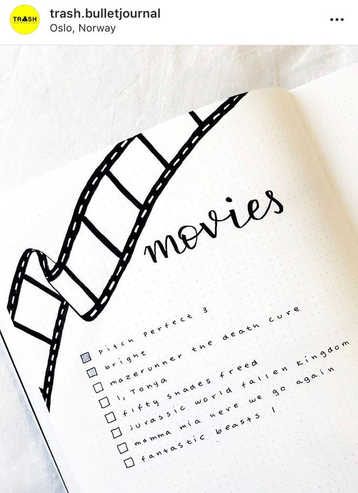 an open notebook with the words movies written on it and a film strip drawn in black ink