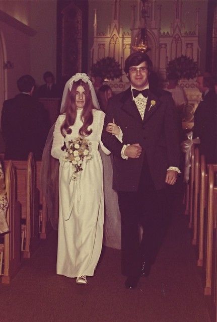 a man and woman are walking down the aisle at their wedding ceremony in an old church