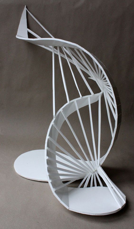 a paper model of a spiral - shaped object on a gray background, with the top half folded down