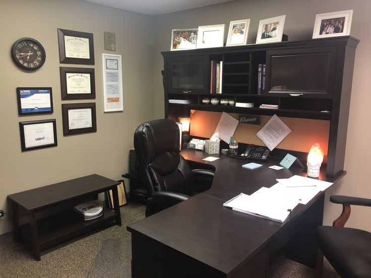 an office with a desk, chair, and bookcase in the middle of it