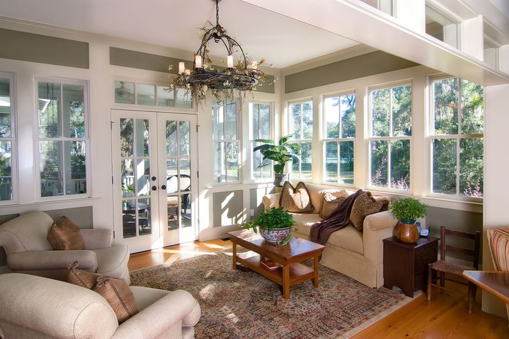 a living room filled with furniture and lots of windows