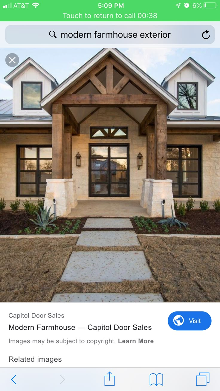 the front entrance to a large home with stone steps leading up to it's entry