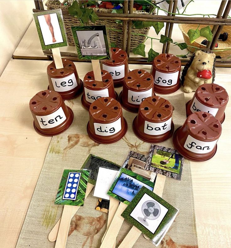 a group of wooden utensils sitting on top of a table next to pictures