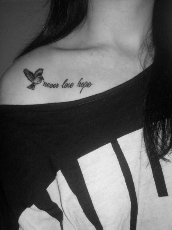 a woman with a small tattoo on her chest saying, you are love to me