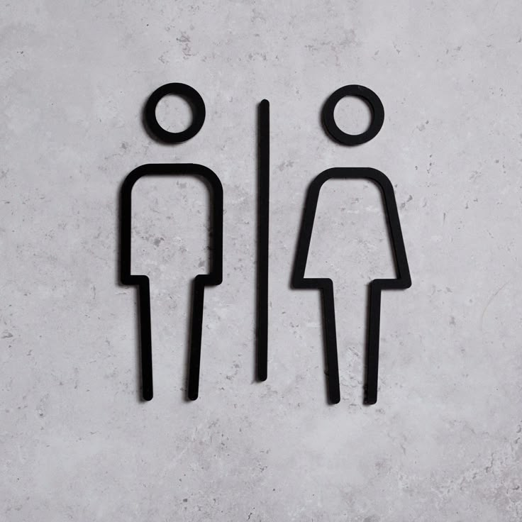 two people standing next to each other in the shape of a man and woman on a wall