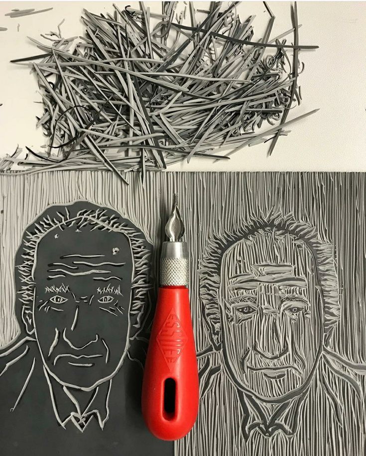 a pair of scissors sitting on top of a piece of paper next to a drawing