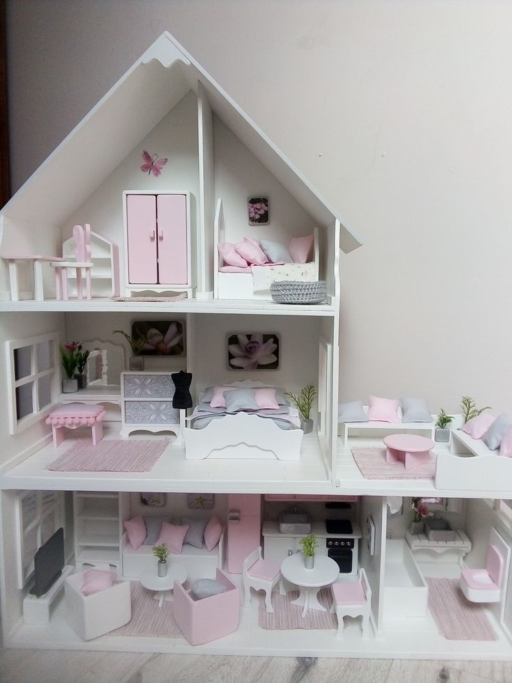 a doll house with all the furniture and accessories in pink, white and grey colors