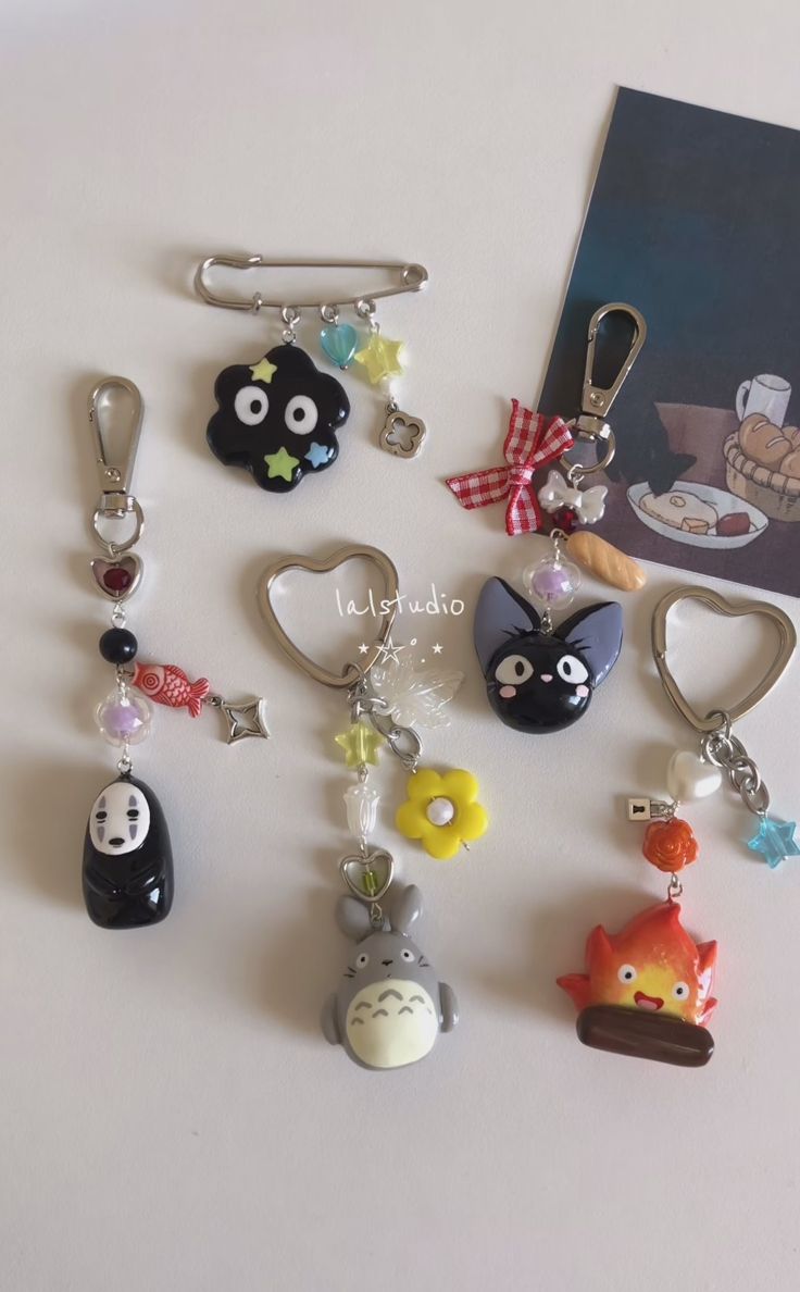 several different key chains and charms on a table