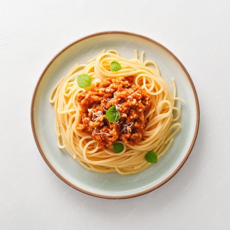 spaghetti with sauce and basil on a plate