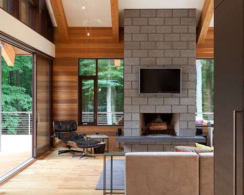 a living room with a fireplace and large windows