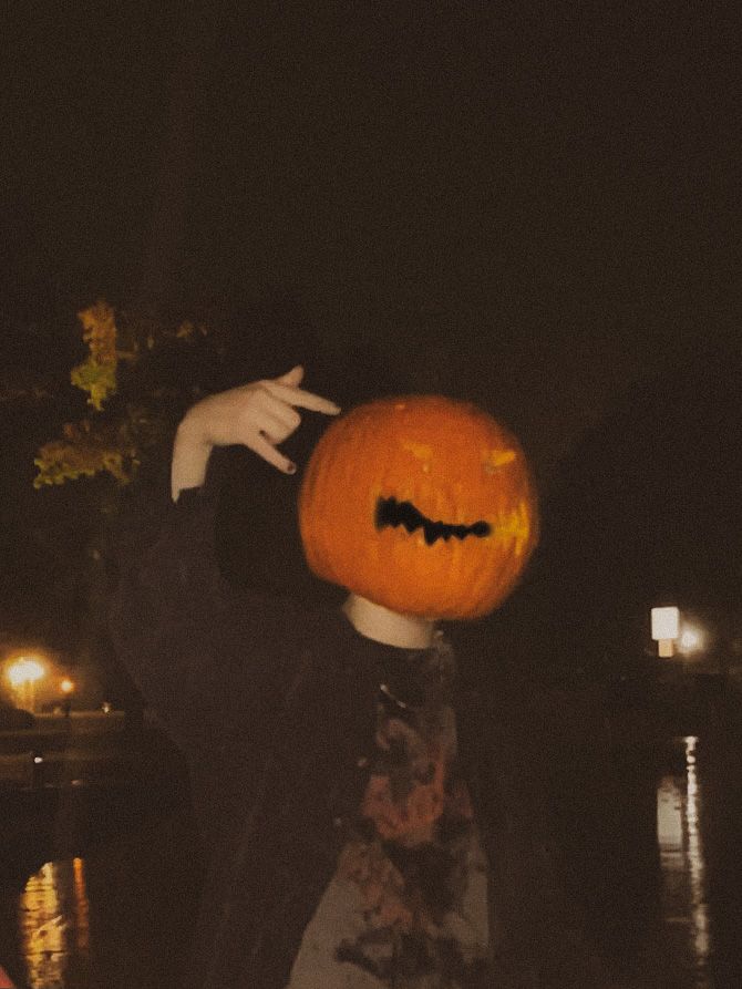 a person wearing a jack o lantern costume