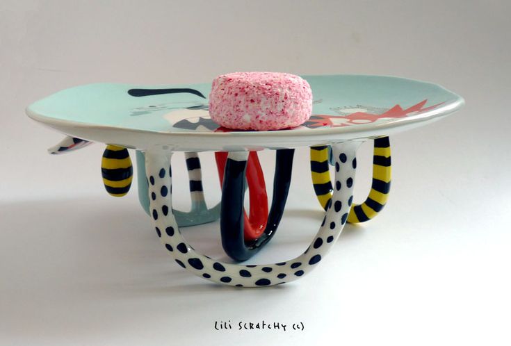 a plate with a cake on top of it sitting on a table in front of a white background