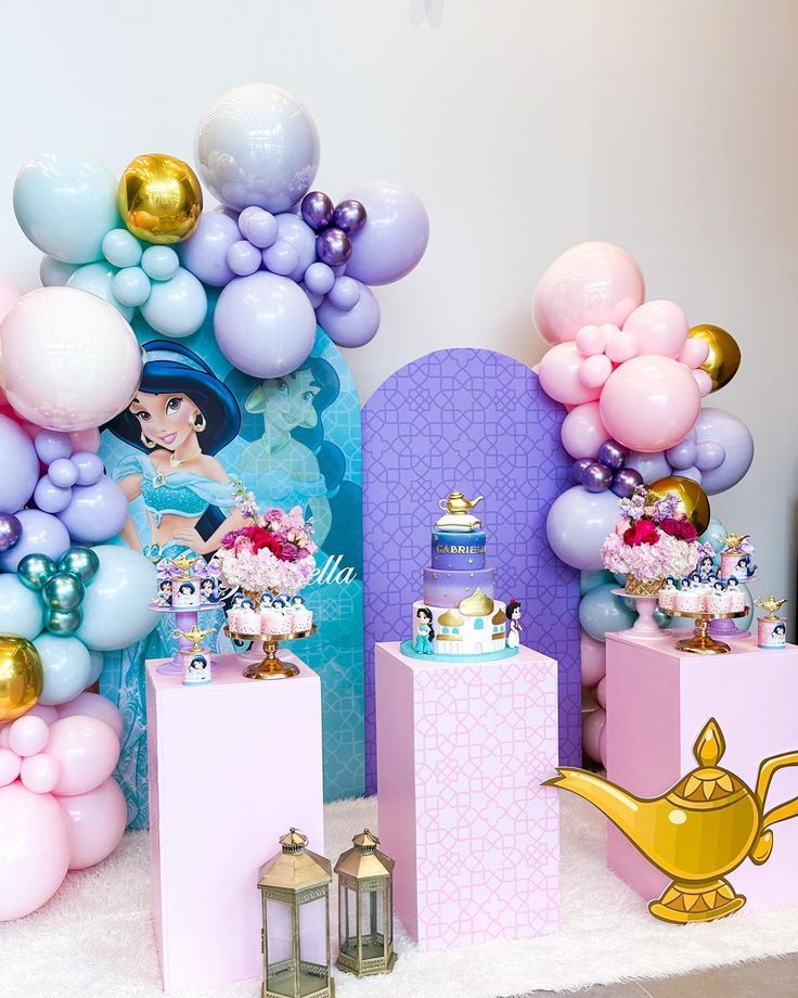 there are many balloons and decorations on the table for a princess birthday party or baby shower