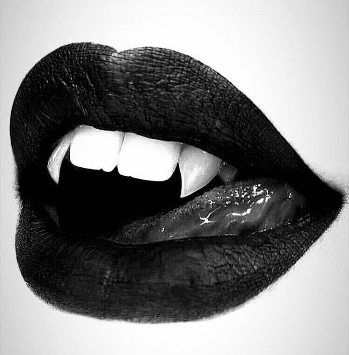 a black and white photo of a woman's mouth with her tongue out to the side